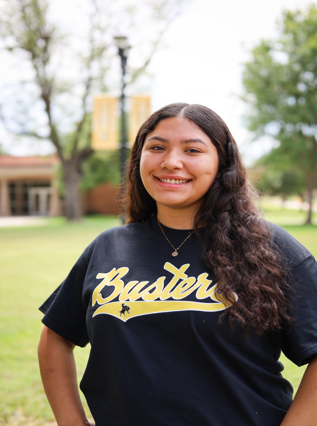 sga student standing in front of campus