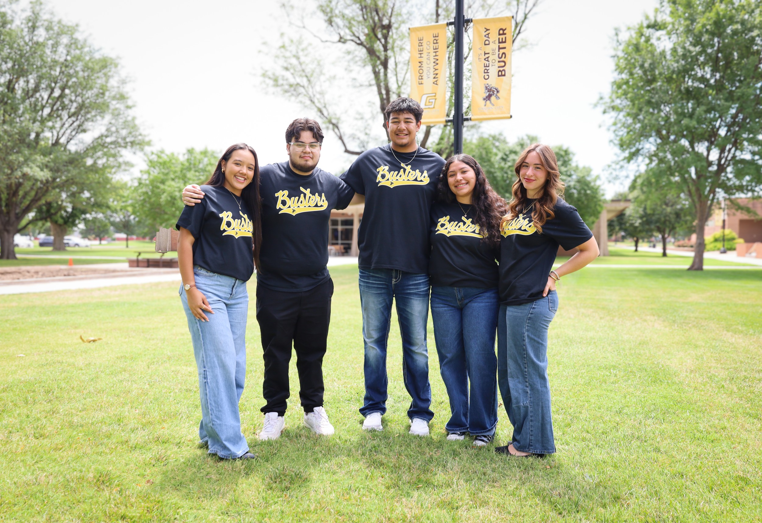 group of students wearing black shirts with "busters" on campus